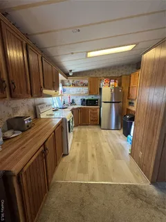 a kitchen with a sink appliances cabinets and a counter top space