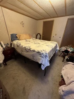 a bedroom with a bed and a chair