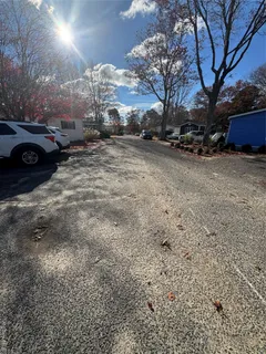a view of road with snow on the roadside