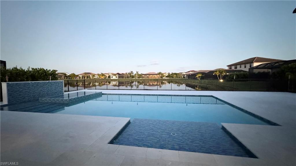 5340 Allen Place Ave Maria, FL 34142 - Photo 16 of 35 View of swimming pool with a residential view, a water view, and a patio area
