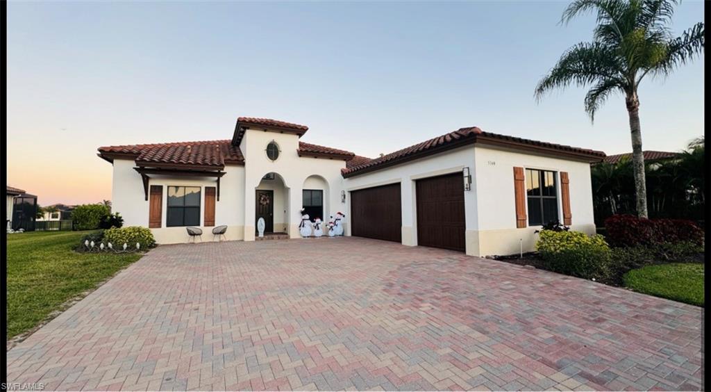 5340 Allen Place Ave Maria, FL 34142 - Photo 2 of 35 Mediterranean / spanish-style home featuring a garage, stucco siding, decorative driveway, and a tile roof