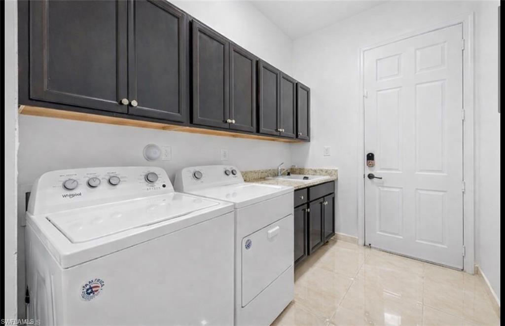 5340 Allen Place Ave Maria, FL 34142 - Photo 21 of 35 Laundry room featuring cabinet space, independent washer and dryer, and light tile patterned floors