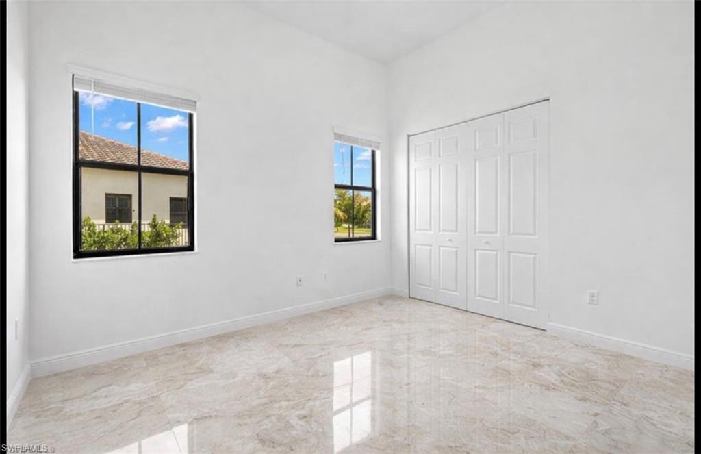 5340 Allen Place Ave Maria, FL 34142 - Photo 5 of 35 Unfurnished bedroom featuring light marble finish floors and a closet