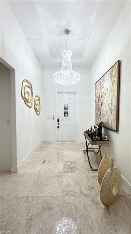 5340 Allen Place Ave Maria, FL 34142 - Photo 7 of 35 Entrance foyer featuring a chandelier and a tray ceiling