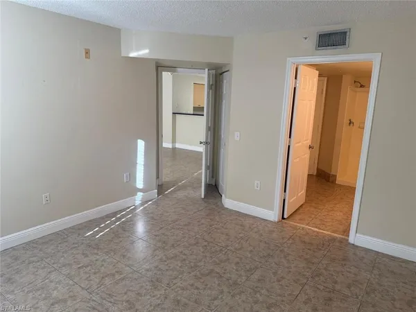 an empty room with windows and closet