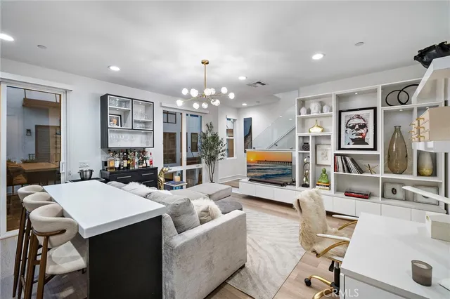 a living room with furniture and chandelier