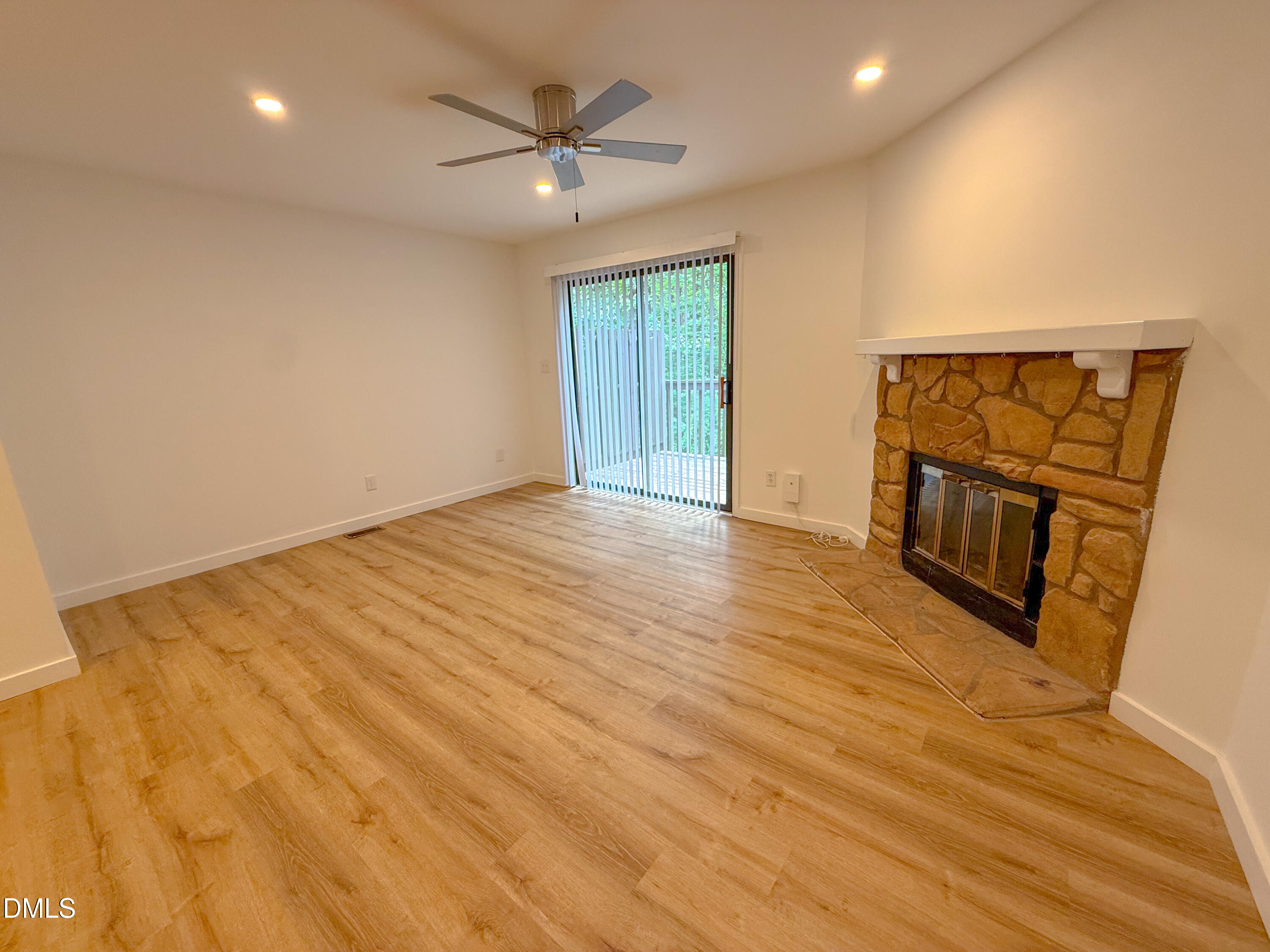 4247 The Oaks Drive Raleigh, NC 27606 - Photo 3 of 21 a view of an empty room with wooden floor and a window