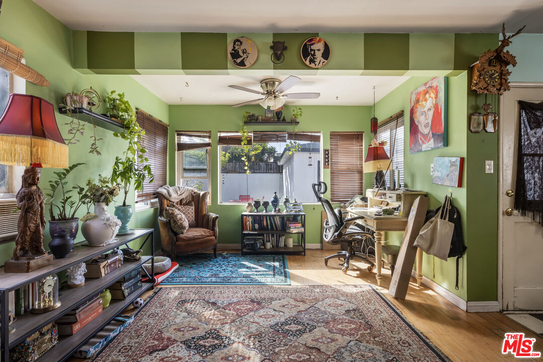 2912 Bellevue Avenue Los Angeles, CA 90026 - Photo 15 of 38 a room with lots of potted plants and a chandelier