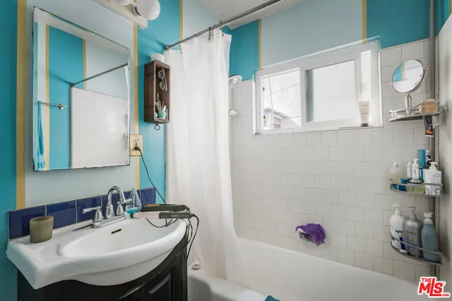 a bedroom with furniture and a flat tv screen