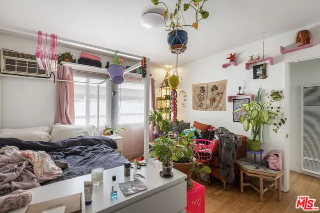 a bedroom with furniture and a flat screen tv