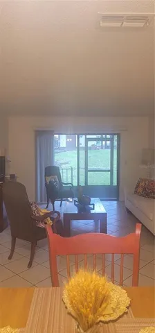 a living room with dining room and wooden floor