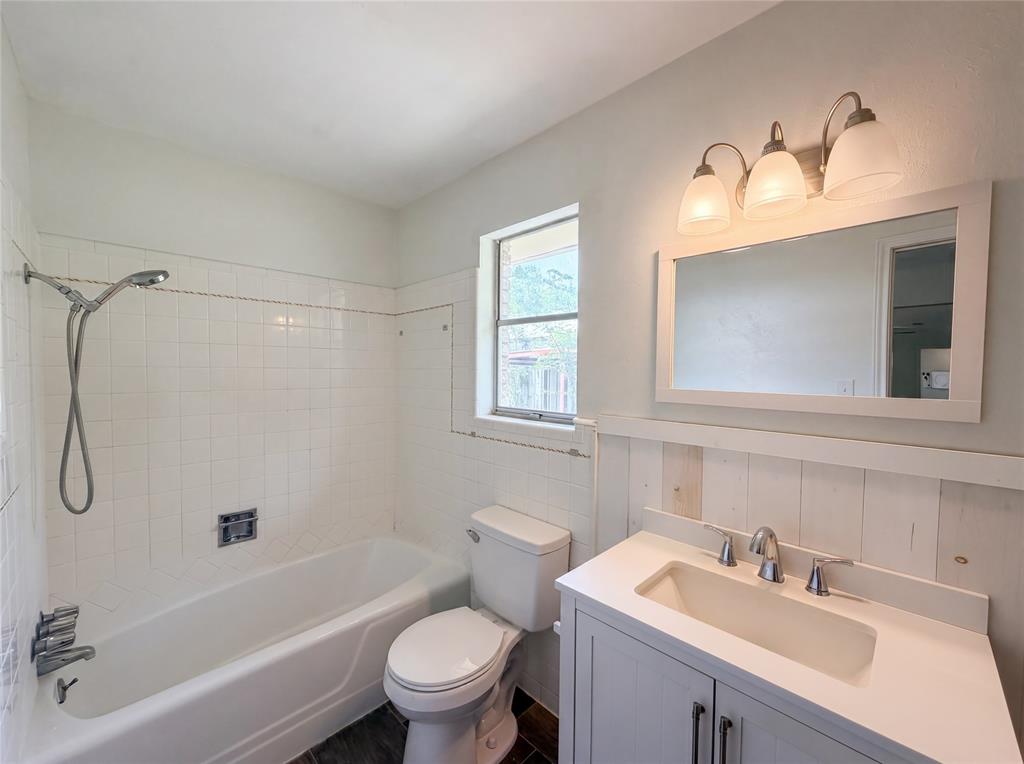205 West Decatur Street Chico, TX 76431 - Photo 14 of 19 a bathroom with a sink toilet and shower