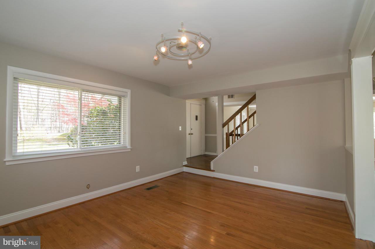 7820 Marconi Court Springfield, VA 22153 - Photo 13 of 29 a view of an empty room with wooden floor and a window