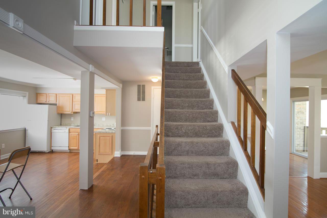 7820 Marconi Court Springfield, VA 22153 - Photo 15 of 29 a view of staircase with lots of frames on wall and couches