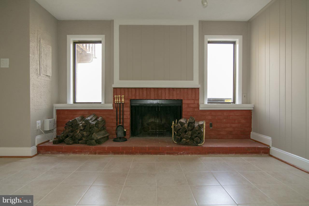 7820 Marconi Court Springfield, VA 22153 - Photo 23 of 29 an empty room with a fireplace and windows
