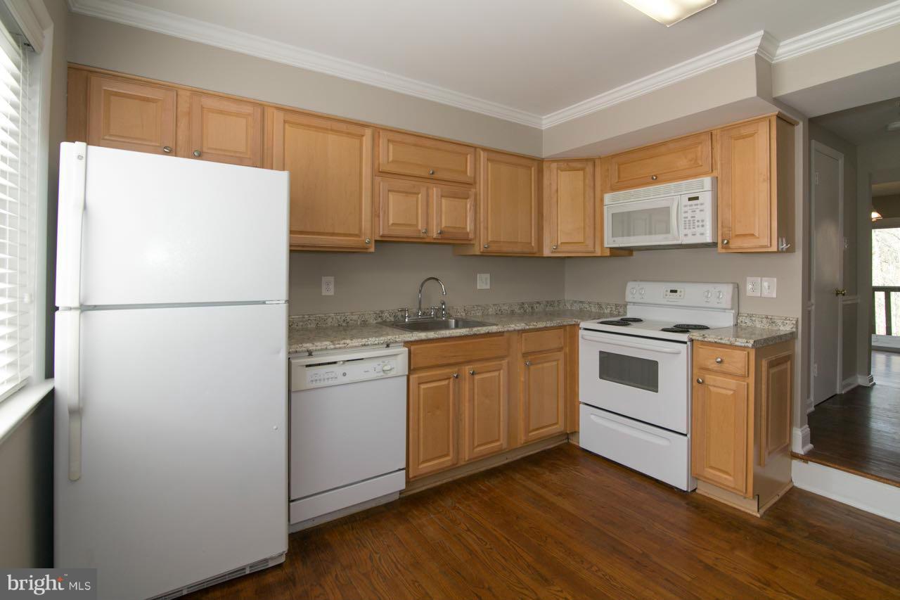 7820 Marconi Court Springfield, VA 22153 - Photo 4 of 29 a kitchen with a refrigerator sink and cabinets