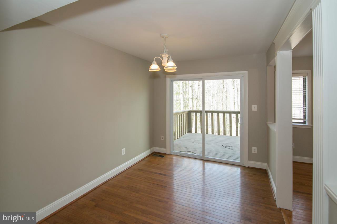 7820 Marconi Court Springfield, VA 22153 - Photo 10 of 29 a view of an empty room with wooden floor and a window