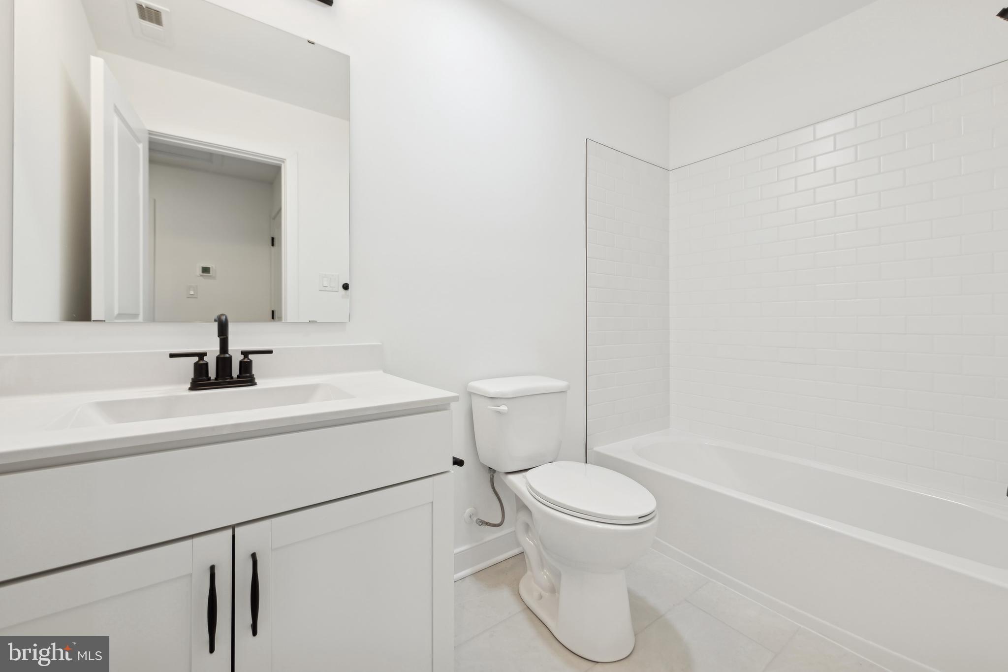 19707 Crows Nest Court Georgetown, DE 19947 - Photo 12 of 30 a bathroom with a sink a toilet and shower