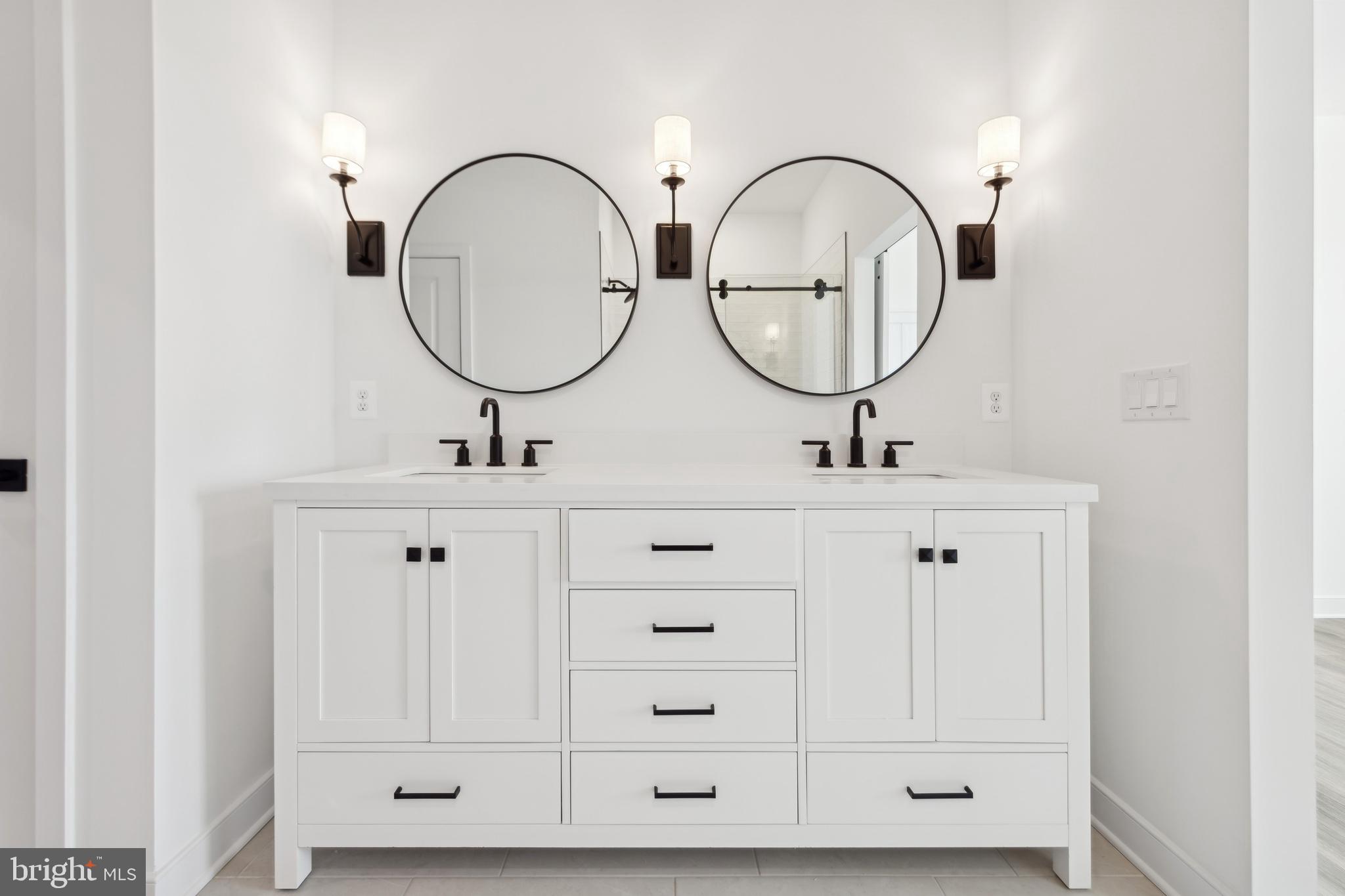 19707 Crows Nest Court Georgetown, DE 19947 - Photo 22 of 30 a bathroom with a sink and a mirror