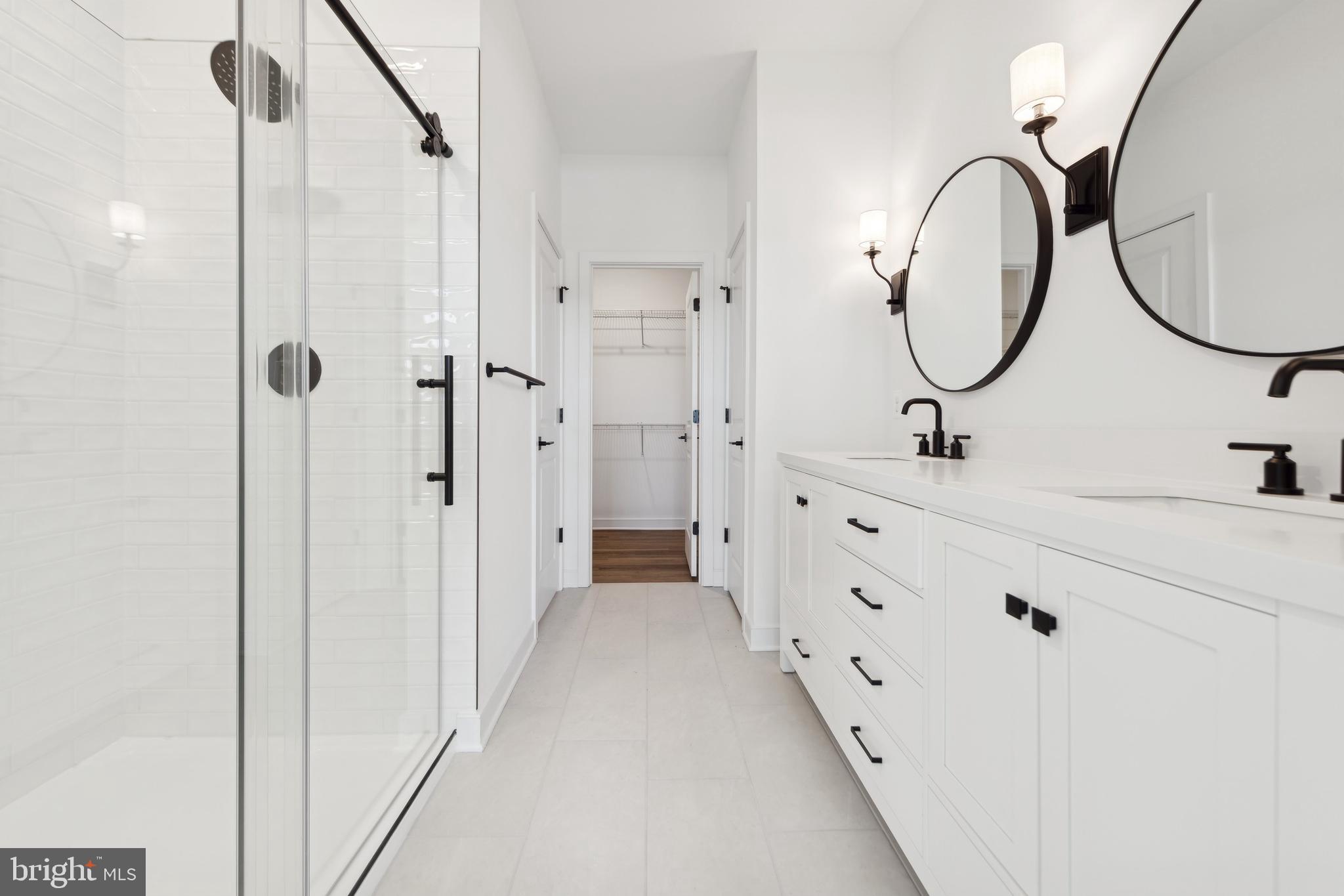 19707 Crows Nest Court Georgetown, DE 19947 - Photo 23 of 30 a bathroom with a double vanity sink mirror and a shower
