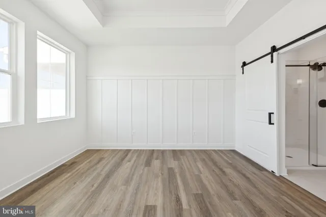 a view of a room with wooden floor closet and windows