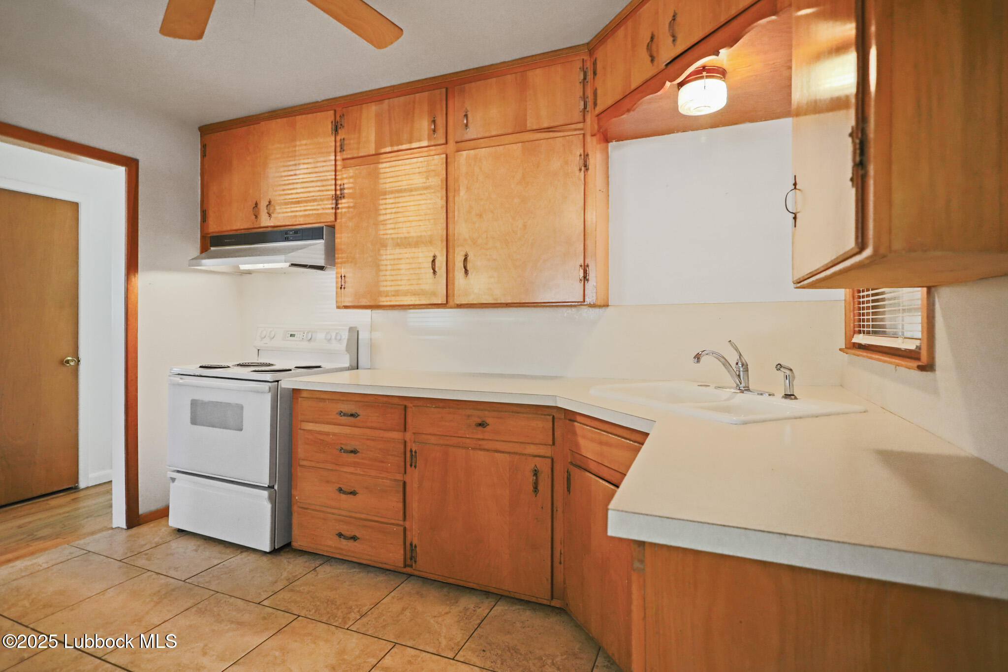 2315 Ithaca Avenue Lubbock, TX 79410 - Photo 11 of 30 a kitchen with granite countertop a sink cabinets stainless steel appliances and a window