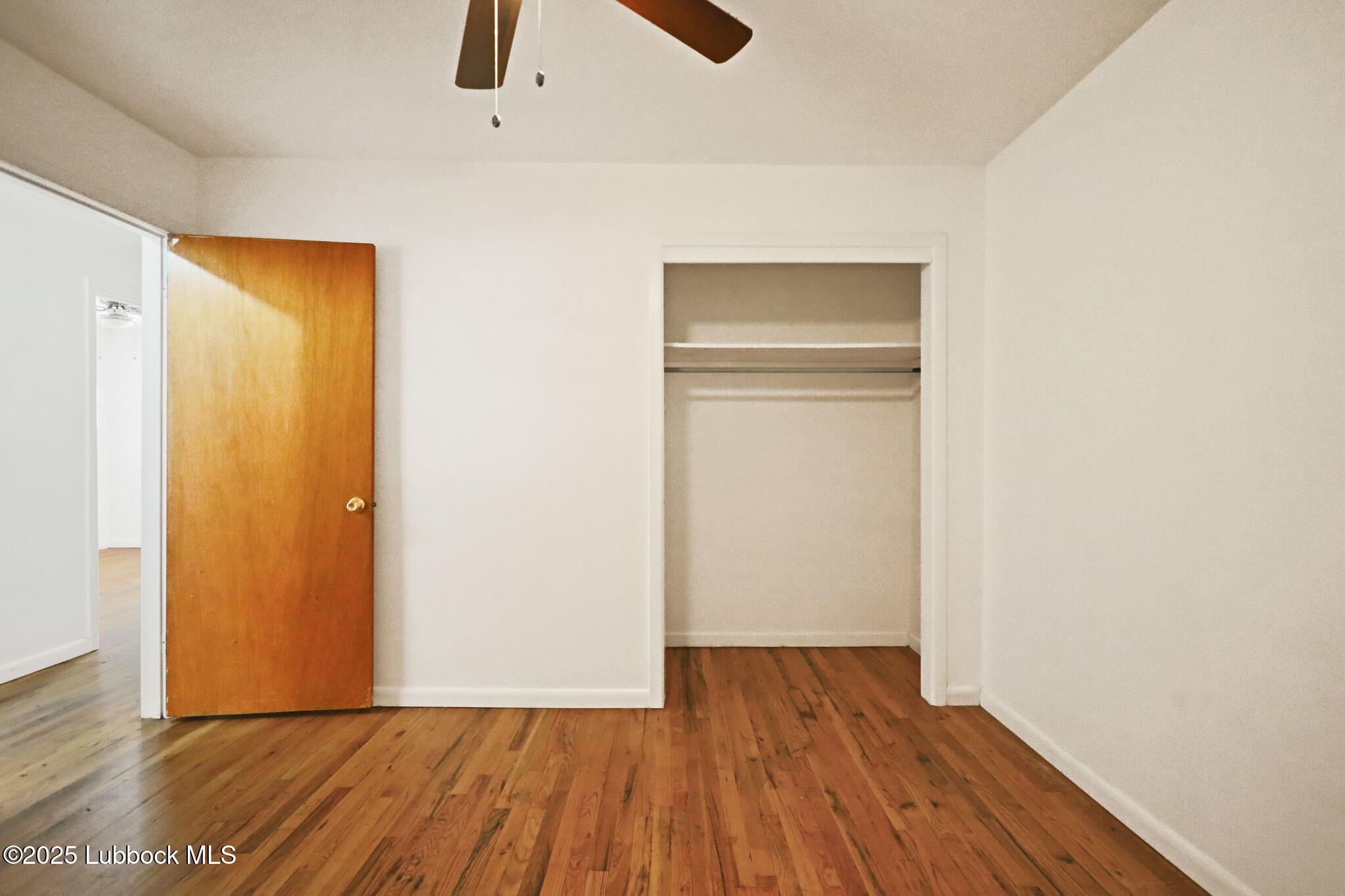 2315 Ithaca Avenue Lubbock, TX 79410 - Photo 15 of 30 a view of an empty room with wooden floor