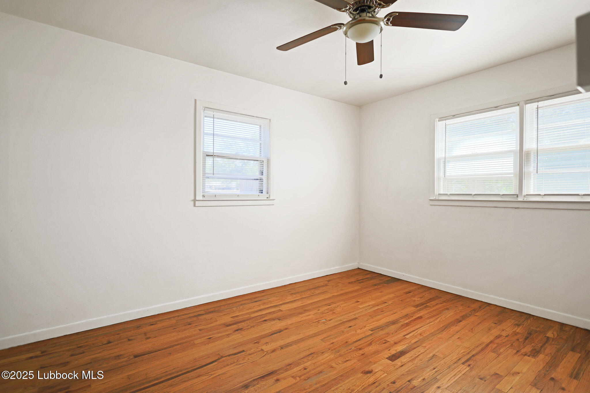 2315 Ithaca Avenue Lubbock, TX 79410 - Photo 16 of 30 a view of empty room with wooden floor and fan