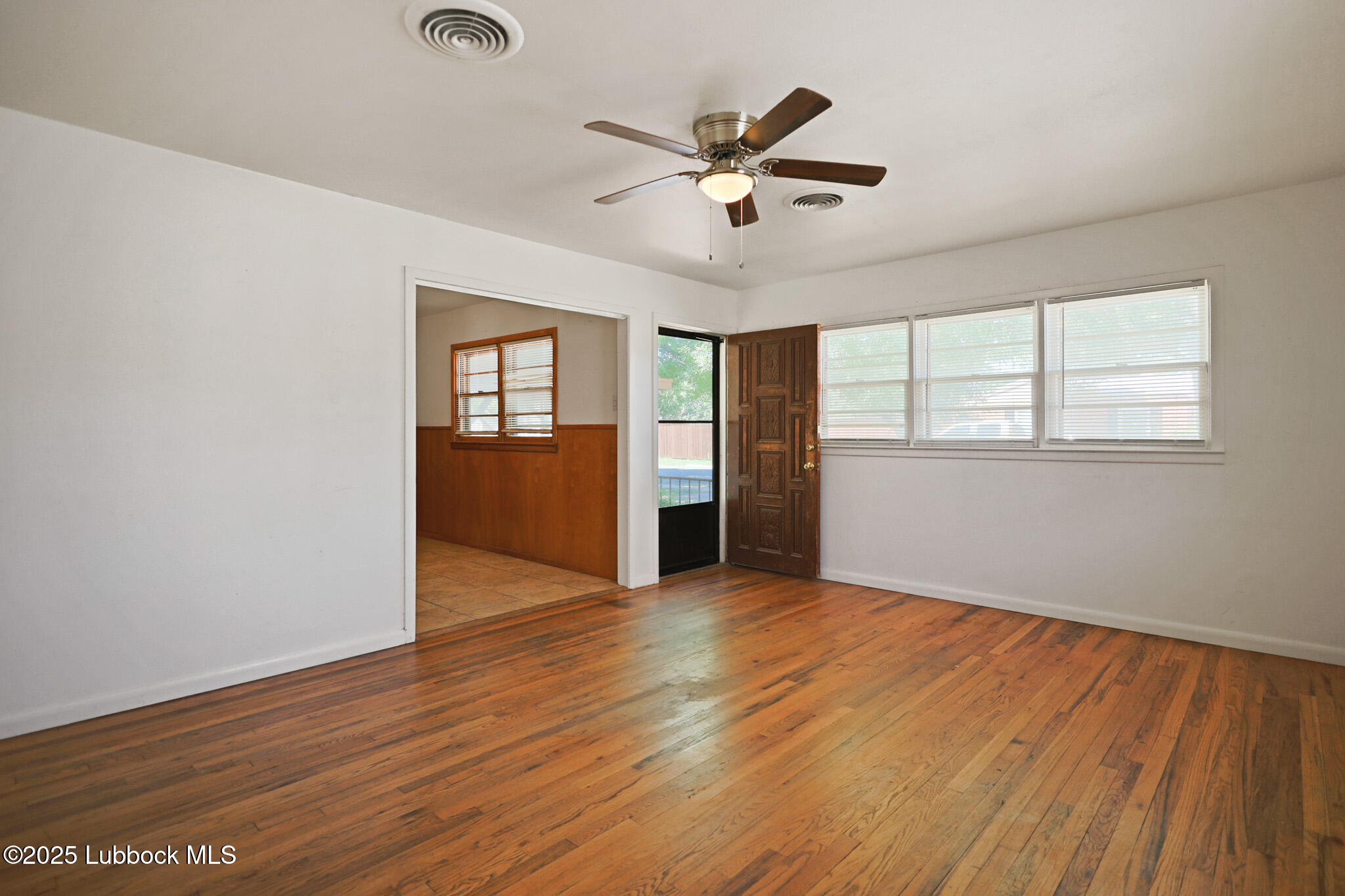 2315 Ithaca Avenue Lubbock, TX 79410 - Photo 8 of 30 wooden floor in an empty room with a window