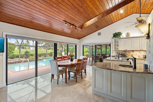 a dining room with furniture a garden and patio