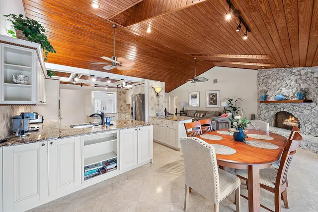 a view of a dining room with furniture and a chandelier