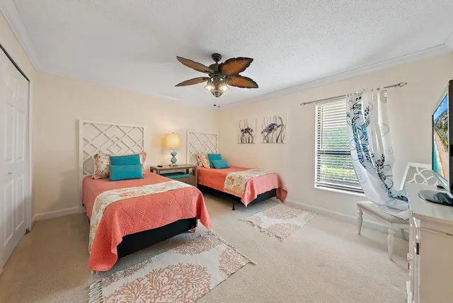 a bedroom with two beds and a chandelier