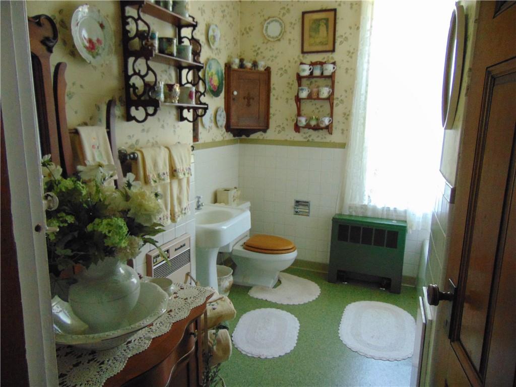 201 Main Street Dawson, PA 15428 - Photo 25 of 25 a bathroom with a toilet mirror and sink