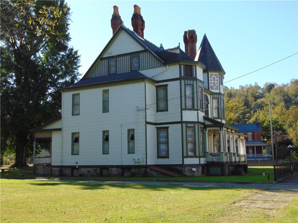 201 Main Street Dawson, PA 15428 - Photo 4 of 25 a front view of a house with a yard