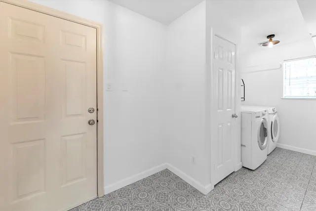 a view of a storage & utility room with a washer dryer