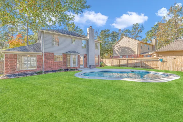 a view of a house with a backyard porch and sitting area