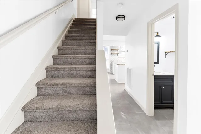 a view of staircase with white walls