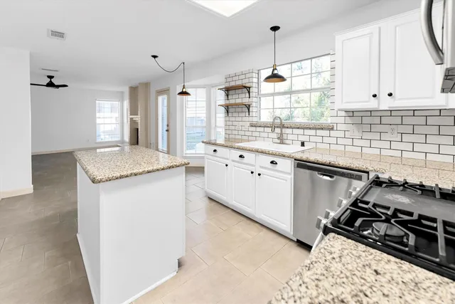 a kitchen with a sink stove and cabinets