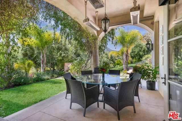 a view of a patio with table and chairs and potted plants