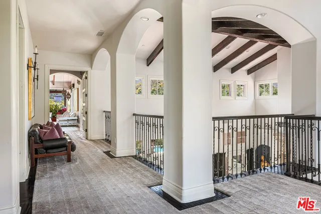 a spacious bedroom with a bed and a large window