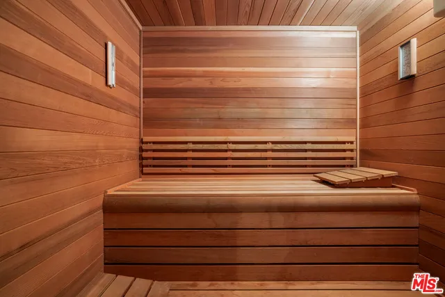 a bedroom with bed and wooden floor