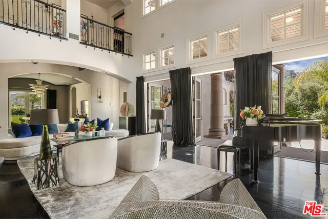 a living room with furniture kitchen view and a refrigerator