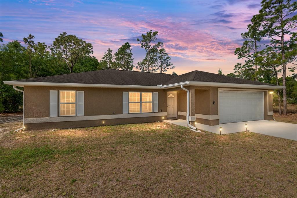 2 Hemlock Loop Drive Ocala, FL 34472 - Photo 1 of 28 front view of a house with a garage