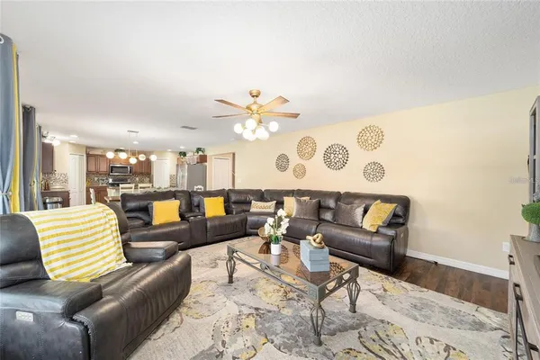 a kitchen with stainless steel appliances kitchen island granite countertop a stove refrigerator and cabinets