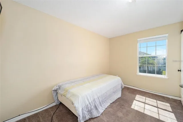 a bedroom with a bed and a mirror