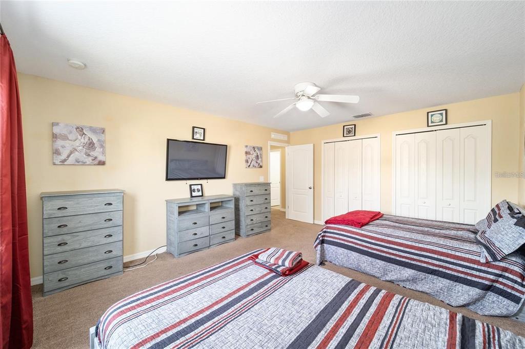 14308 Northwest 161st Avenue Alachua, FL 32615 - Photo 28 of 52 a bedroom with a bed and a flat screen tv