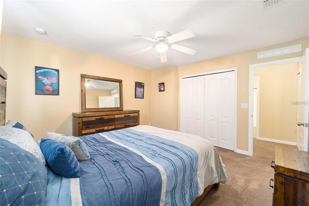 14308 Northwest 161st Avenue Alachua, FL 32615 - Photo 30 of 52 a bedroom with a bed and a chandelier