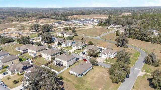 an aerial view of a house with a yard