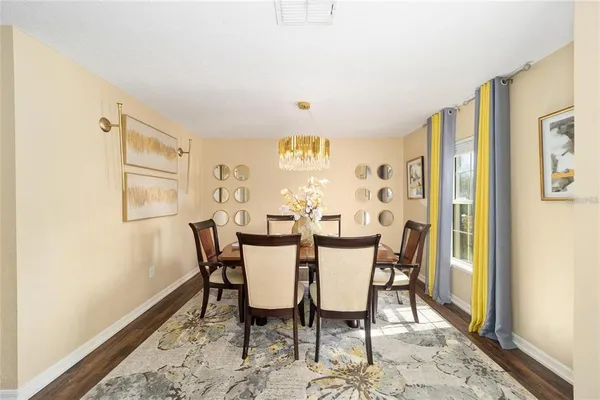 a view of a dining room with furniture and wooden floor
