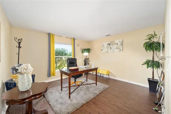 a view of a workspace with furniture and wooden floor
